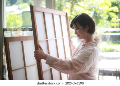 A woman who replaces shoji 
 - Shutterstock ID 2024096198