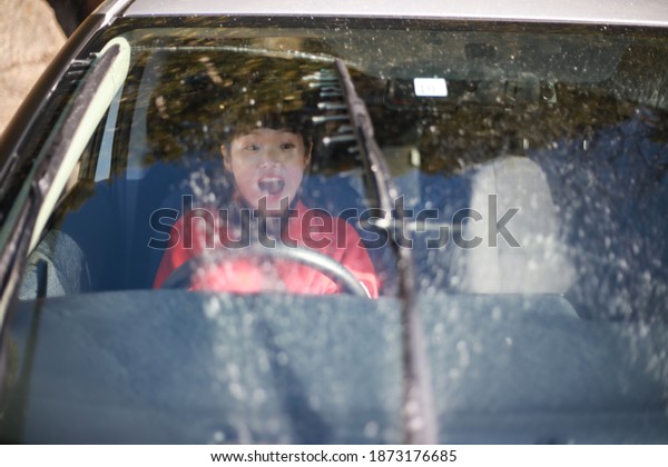 A woman who is\
surprised by the washer fluid