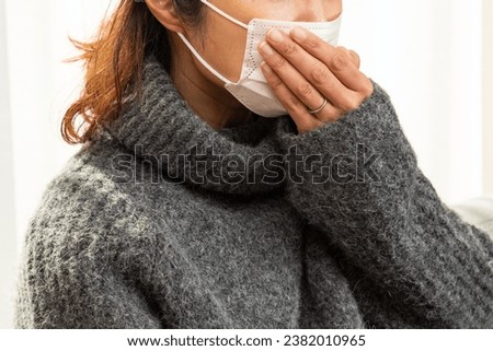 A woman who is unwell and coughs.