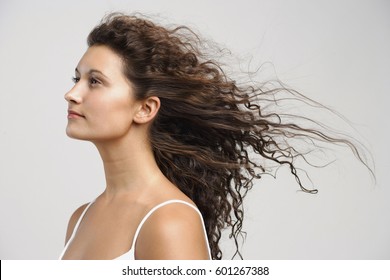 woman with wind blowing in face, eyes open