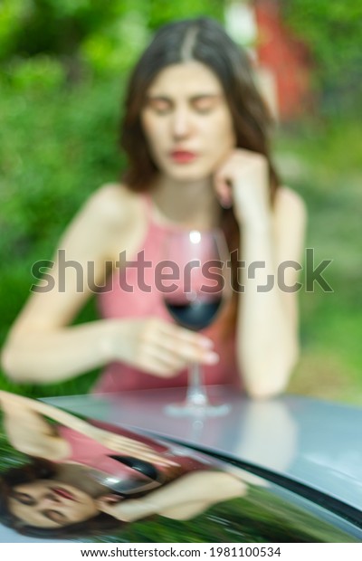 woman with wine, woman with glass of wine, woman\
drinking red wine in the\
garden