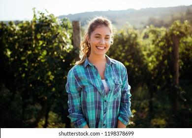 Woman Winemaker With Grapes In A Vineyard