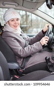 Woman In Winter Clothes Driving A Car