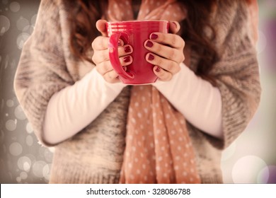 Woman In Winter Clothes Holding A Hot Drink Against Autumnal Leaf Pattern