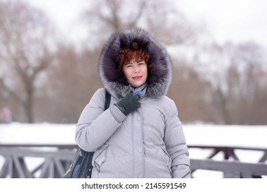 Woman In Winter In A Gray Jacket With Fur Trim