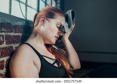 Woman Wiping Away Her Sweat With A Gym Towel