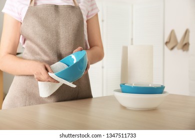 Woman Wiping Bowl With Paper Towel In Kitchen, Closeup