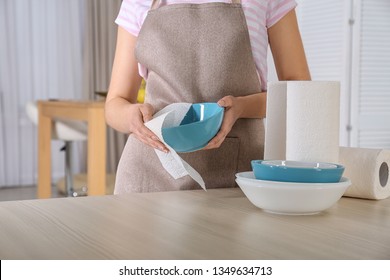 Woman Wiping Bowl With Paper Towel In Kitchen, Closeup