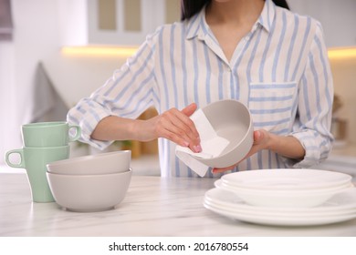 Woman Wiping Bowl With Paper Towel In Kitchen, Closeup