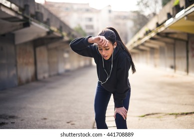 Woman Wiping Sweat From Forehead After A Heavy Training.