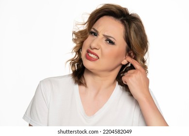 Woman Wit An Itchy Ear, Isolated On White Background.