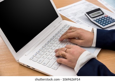 woman work at laptop and filling tax form