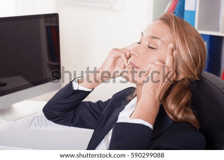 Woman at work massing her temples