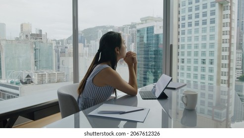 Woman Work With Tablet Computer And Think The Problem Look At City Outside Window