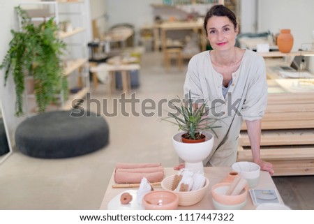 Similar – Woman in work wear in her workshop by table with handmade items