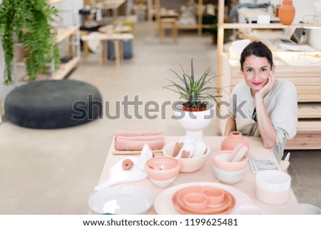 Similar – Woman in work wear in her workshop by table with handmade items