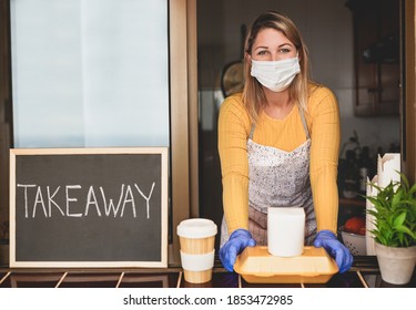 Woman at work wearing surgical face mask and gloves - Take away food and drink - Powered by Shutterstock