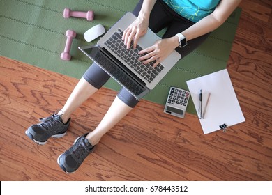 Woman Work And Workout At Home For Healthy Concept And Work Life Balance.  With Laptop And Workout Equipments. Top View.