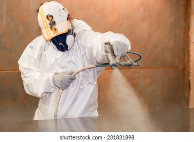 Woman Worker Painting Wooden Board With Spray.