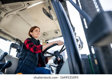 Woman Worker Riding Tractor On Diary Farm, Agriculture Industry.