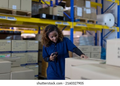 Woman worker using barcode machine checking products or parcel goods on shelf pallet in industry factory warehouse. Inspection quality control - Powered by Shutterstock