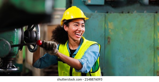 Woman worker wearing safety goggles control lathe machine to drill components. Metal lathe industrial manufacturing factory - Powered by Shutterstock