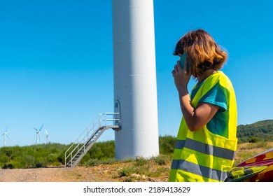 A Woman Worker In A Wind Farm, Green Energy, Technical Review, Sitting In The Car Making A Call