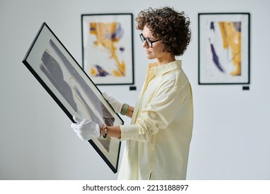 Woman working with art at gallery