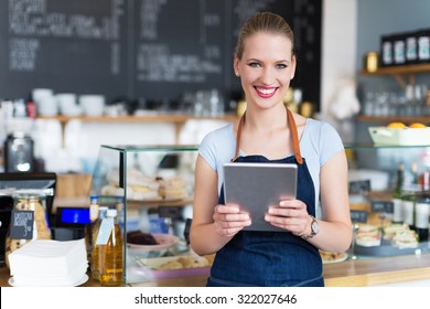Woman working at cafe - Shutterstock ID 322027646
