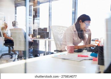 Woman working at computer in an office - Shutterstock ID 275814077