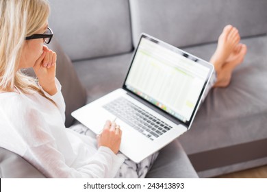 Woman Working With Computer While Sitting On Couch