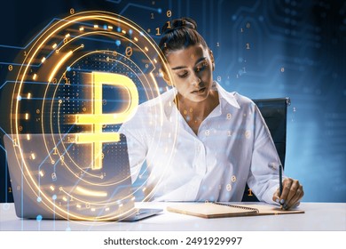 Woman working at a desk, with a glowing digital ruble symbol hologram in the foreground. Blue technological background. Concept of digital currency and blockchain technology - Powered by Shutterstock - Get 15% off with code: PIKWIZARD15