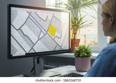 woman working with digital land registry database on computer in office - Shutterstock ID 1865168719