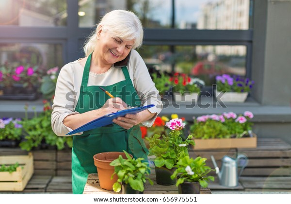 Woman working in florist\
shop\
