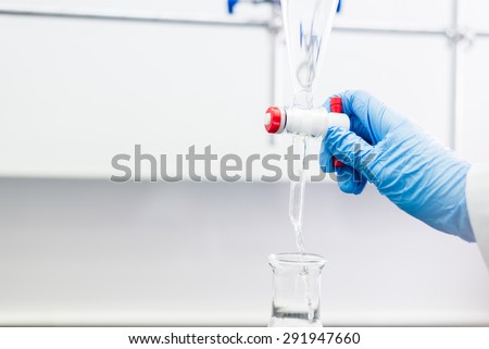 Woman working with a Funnel in a Organic Chemistry Lab