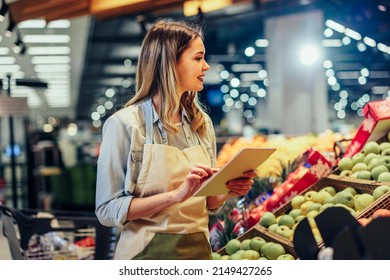 Woman working at a grocery store doing the inventory - small business concepts - Powered by Shutterstock