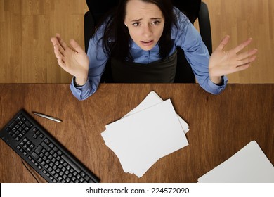 Woman Working At Her Desk Not Happy About Her Work Load, Taken From A Birds Eye View