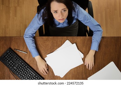 Woman Working At Her Desk Not Happy About Her Work Load, Taken From A Birds Eye View