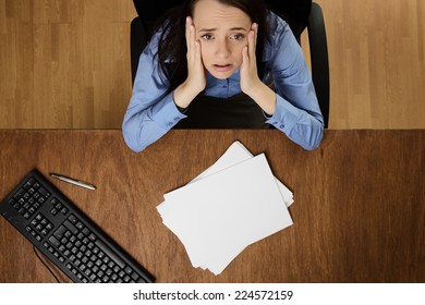 Woman Working At Her Desk Not Happy About Her Work Load, Taken From A Birds Eye View