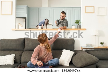 Woman working at home with laptop. Your partner serves you a coffee. Domestic scene.