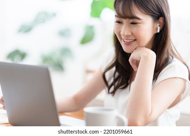 Woman working from home in the living room - Shutterstock ID 2201059661