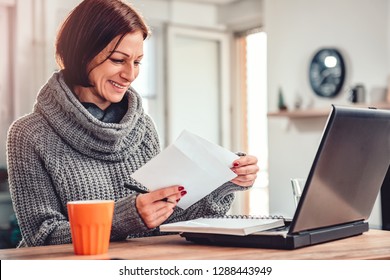 Woman Working At Home Office And Opening Letter