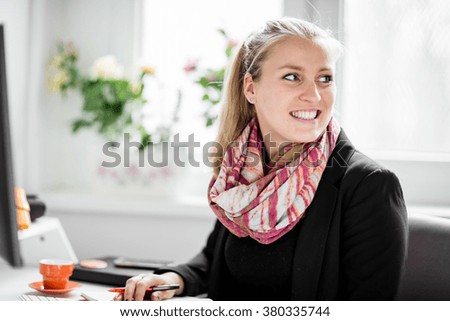 Similar – Entrepreneur woman wearing red shirt working with a laptop sitting on a couch at home