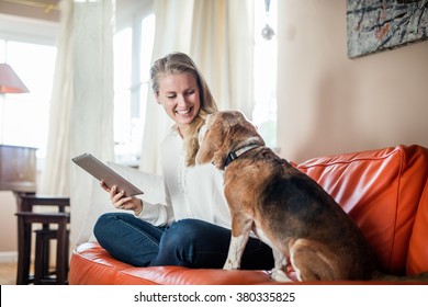 Woman Working From Home On Her Relaxing Orange Couch