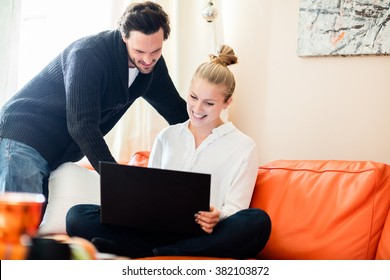 Woman Working From Home On Her Relaxing Orange Couch