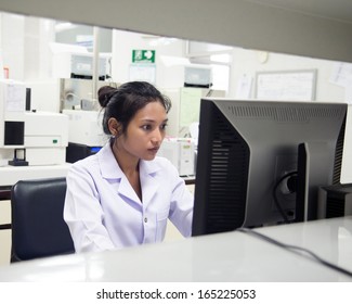 Woman Working In A Laboratory. Doctor Working On A Computer In The Office Of The Hospital. Medical Staff Use A Computer In A Laboratory. Scientist Doing Research In A Lab With A Computer.