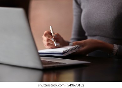 Woman Working With Laptop In Cafe