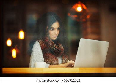 Woman Working With Laptop In Cafe