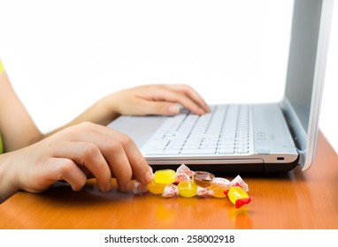 Woman Working At The Laptop Eating A Candy Sweet