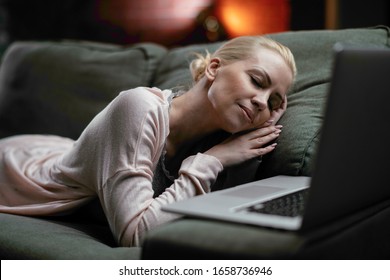Woman working at night at home. Beautiful businesswoman working on laptop at sofa.  - Shutterstock ID 1658736946